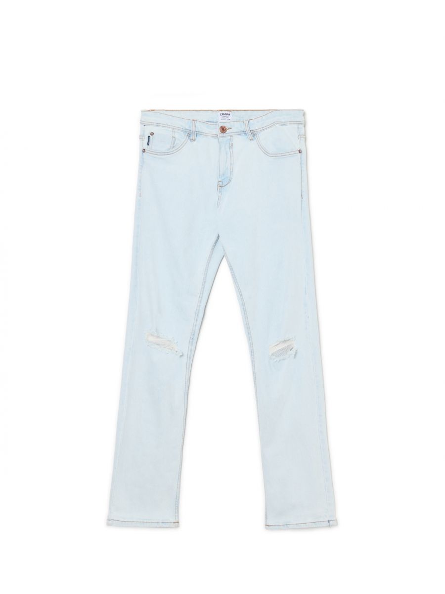 Jasne jeansy z przetarciami na kolanach