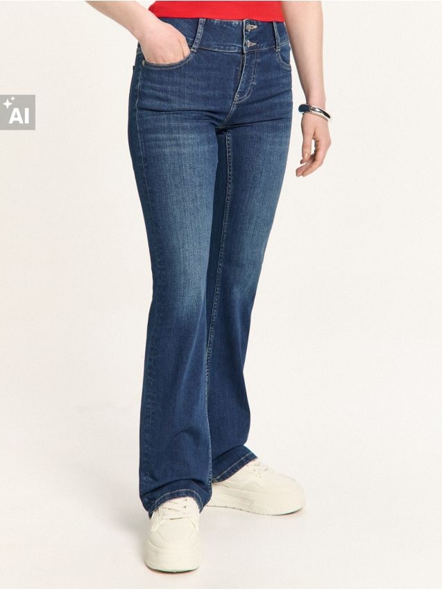 Granatowe jeansy bootcut z efektem sprania